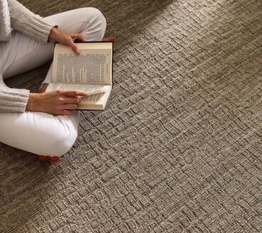 Woman reading on carpet